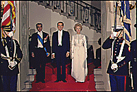 The Shah of Iran, President Nixon, and Mrs. Nixon in formal attire for a state dinner in the White House, 10/21/1969 - ARC Identifier: 194302.